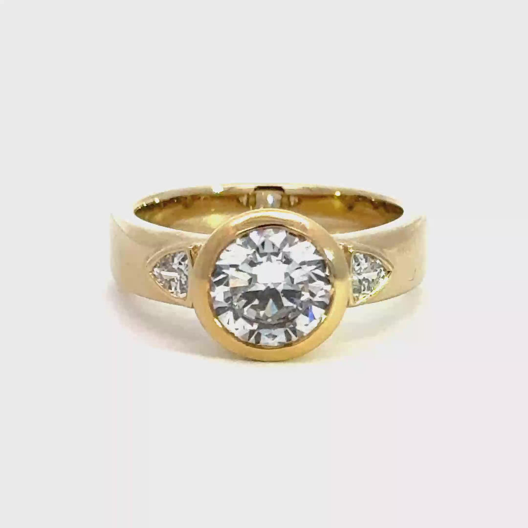 2.2 ctw round diamond bezel three-stone trillion wide band engagement ring